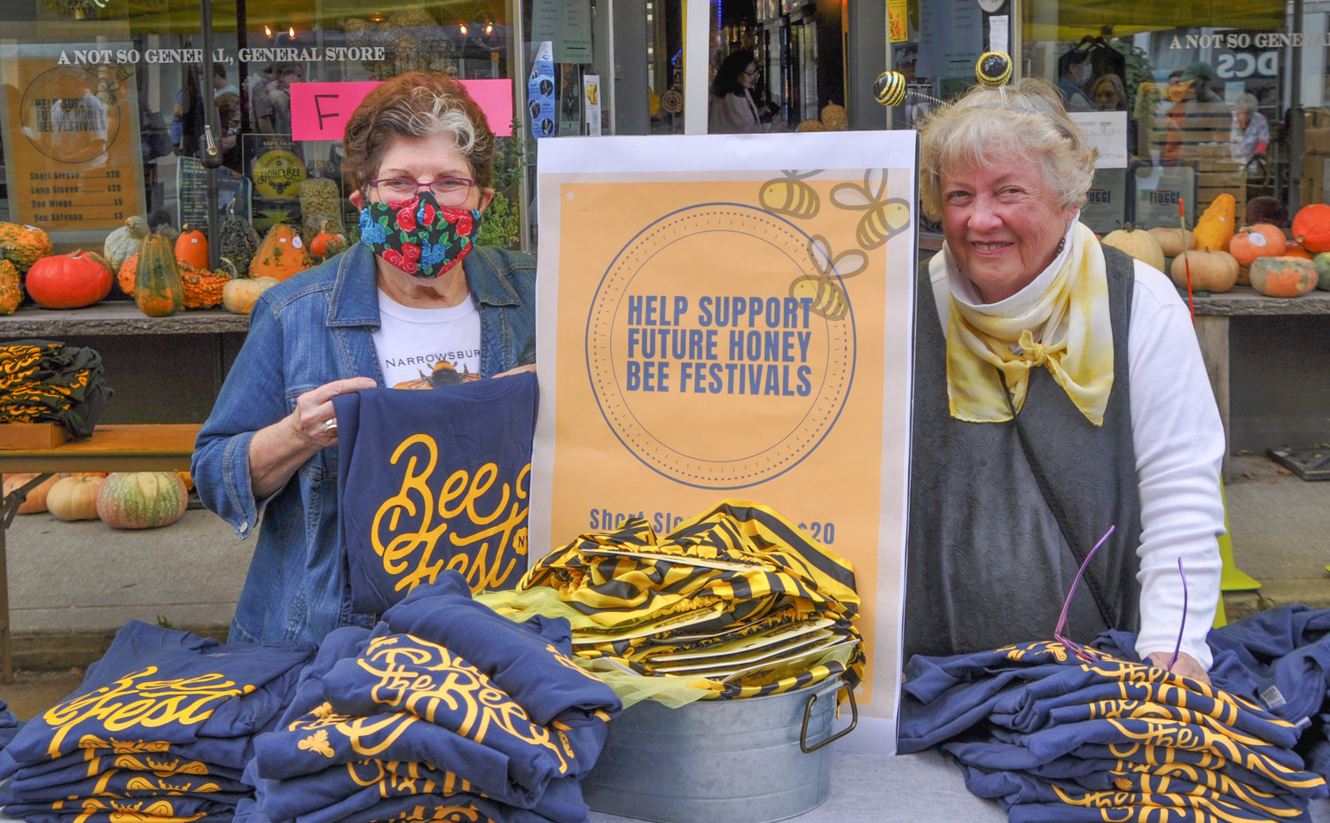 Iris Helfeld, left, and Jane Luchsinger welcome visitors to Honeybee festival on Saturday. The 4 to 8 p.m. celebration highlights the importance of health bee populations.
